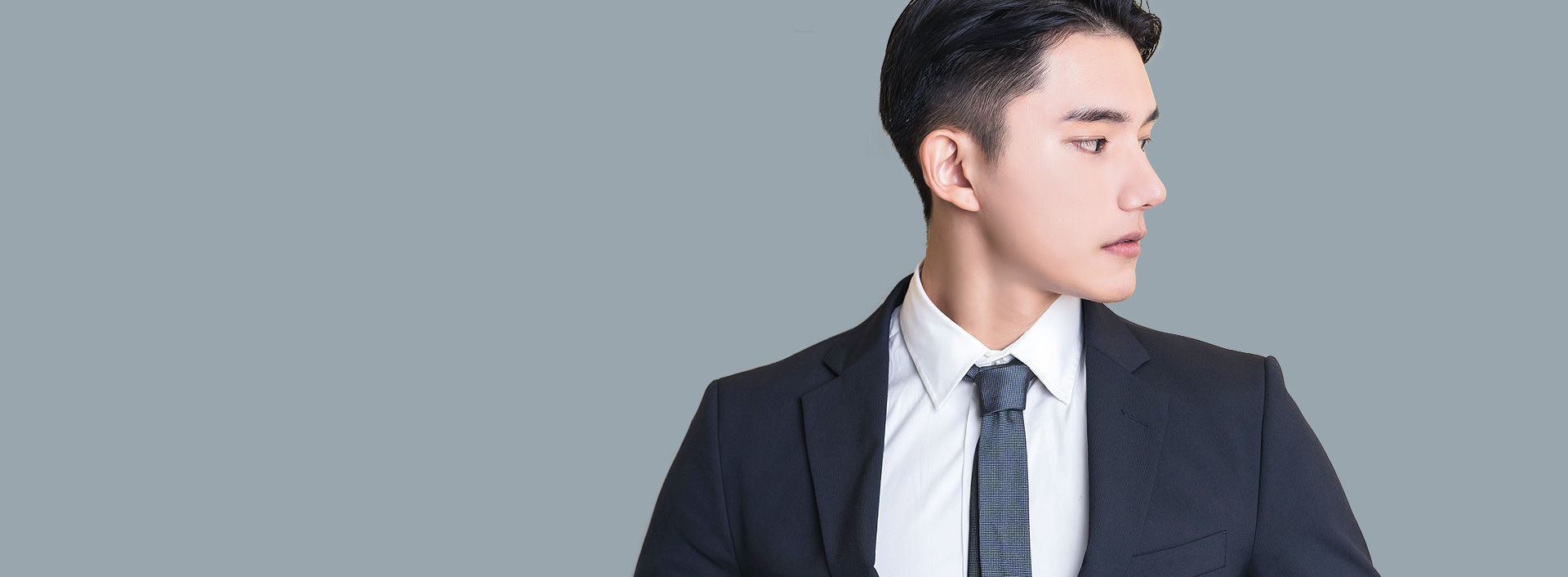 Men's Rhinoplasty banner featuring a man in a neat suit showing his side nose profile