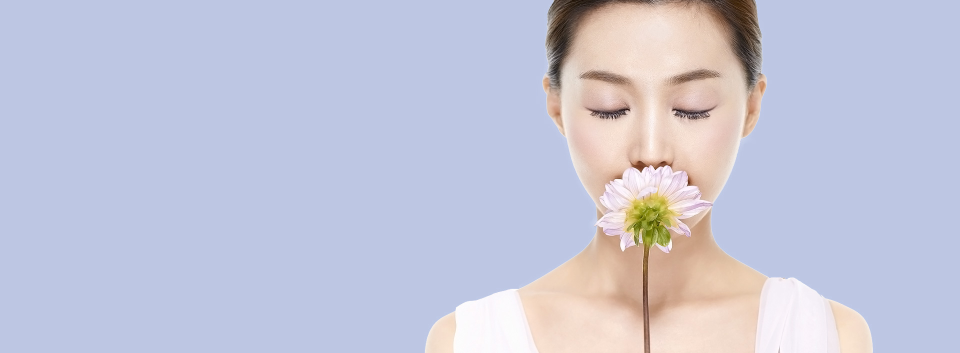 Top banner for the Skin Laser clinic featuring a clean-skinned female model holding a pale pink flower near her nose with eyes closed against a light purple background