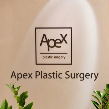 Illuminated interior wall featuring the APEX Plastic Surgery logo in English and Korean